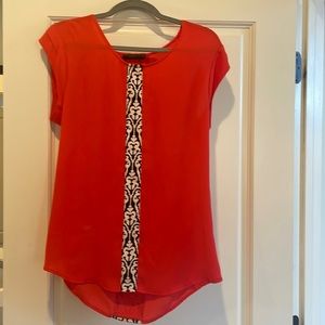 Red blouse with black and white detail.